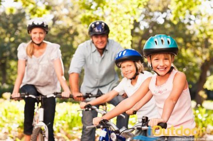 family wearing helmets on a bicycle