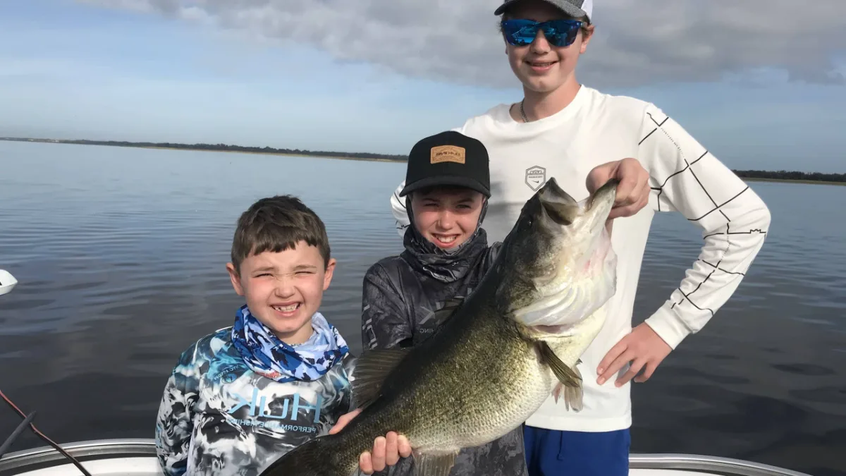 Kids holding a Lake Toho largemouth bass