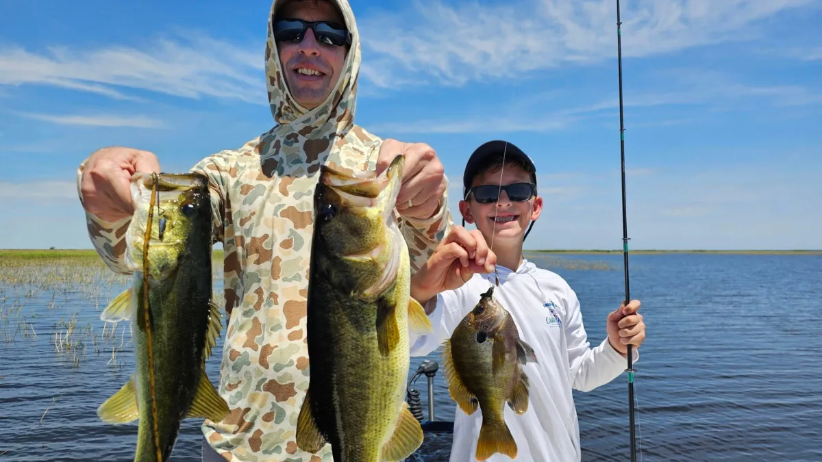 Father and son holding largemouth bass on Lake Okeechobee