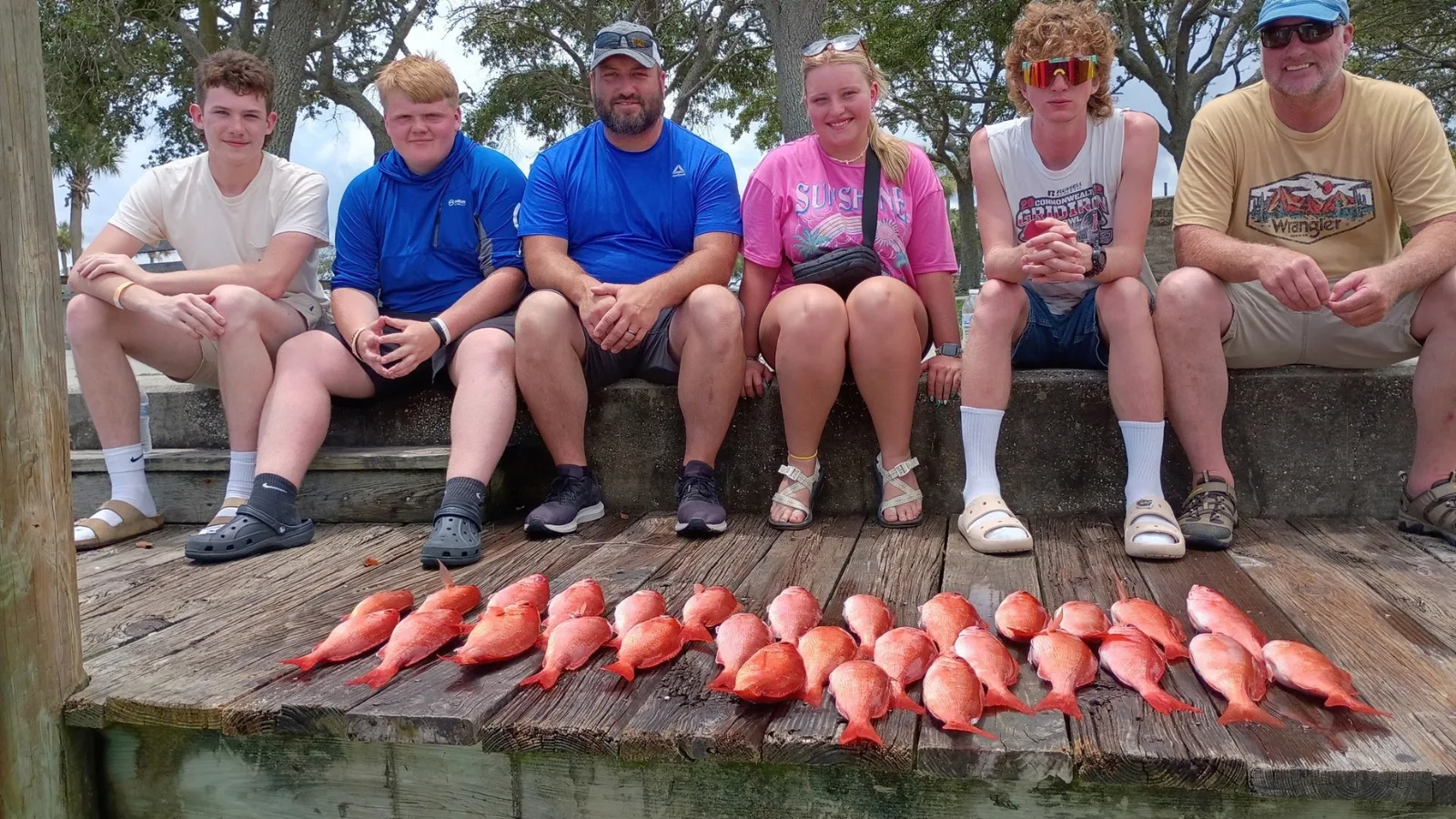 Group of anglers at the dock behind a row of red snapper caught out of Ponce Inlet near New Smyrna Beach